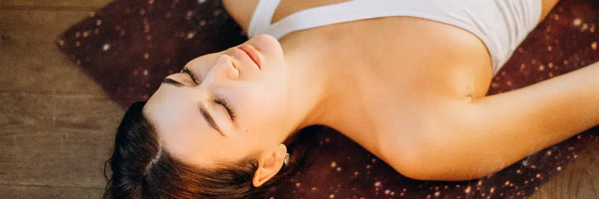 ahb_comfortable-safe-bodywork-therapies Woman lying comfortably on ground, feeling safe, with trust and confidence