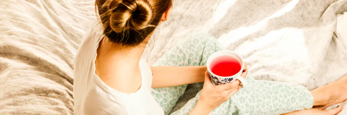 Sitting woman with tea illustrating bodywork self-care to allow somatic and psychosomatic changes to unfold